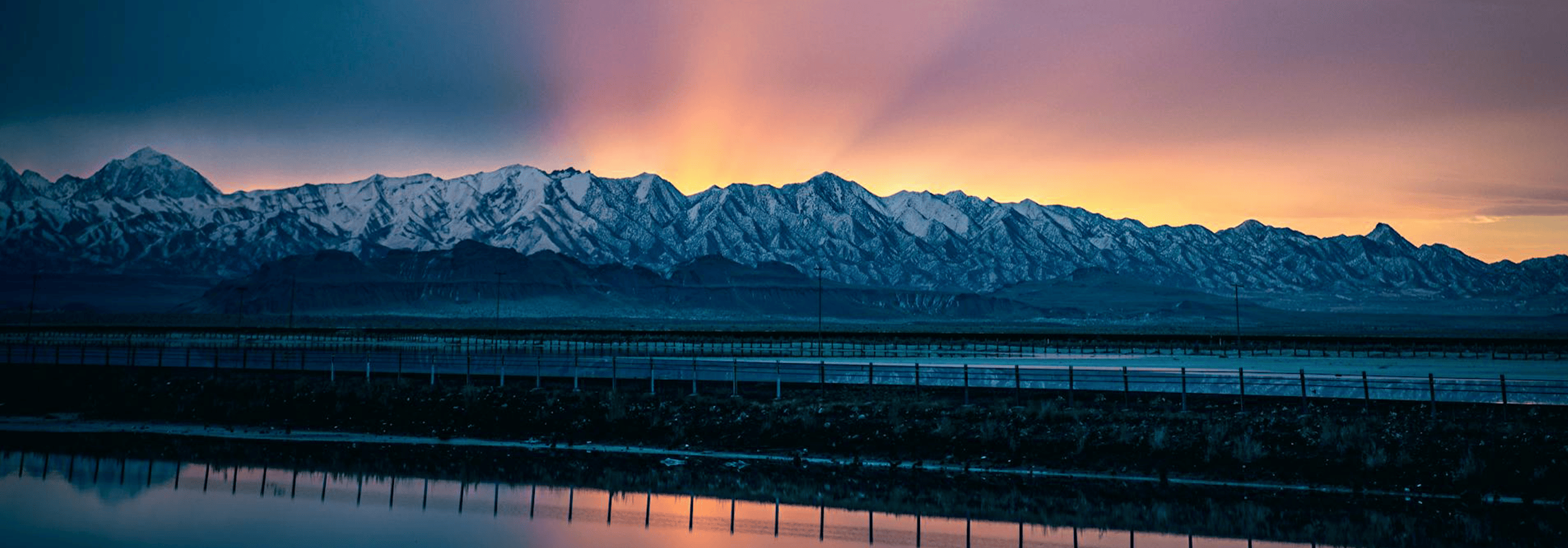 sunrise over mountains and water