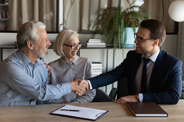 agent shaking hands with a couple